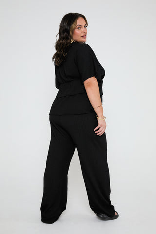 Textured loose fit peplum top in black